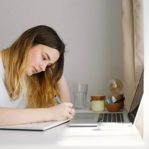 A teenage girl is drawing or doing homework in the bedroom. A teenager studies at home. UPSC Mastery